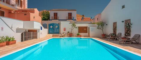 Seasonal outdoor pool, pool loungers