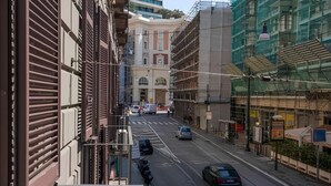 A street view with buildings, a crosswalk, and parked cars. - Arcoleo Prestige 2 By Dimorra (NAPOLI)