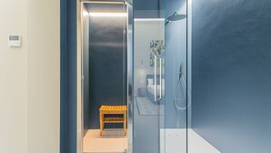 A modern bathroom with a glass enclosure, a shower, and a small wooden bench. - Cognetti Suite 2 in Bari (Bari)