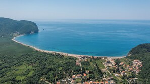 Overlooking the beach, this coastal town offers a scenic view of the sea and surrounding hills.