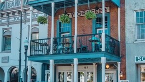 Un edificio con un letrero que dice "City Grocery" y el número "152" sobre la entrada.