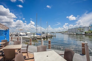 Outdoor dining - Waterfront 1BR condo with 2 baths, pool, marina, and WiFi. (Marco Island)