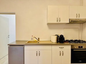 Fridge, coffee/tea maker, cookware/dishes/utensils, dining tables