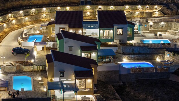 A resort with multiple swimming pools, outdoor seating areas, and a well-lit entrance. - Villa Ariadni Agia pelagia close to the beach up to7-8 quests (Agia Pelagia)