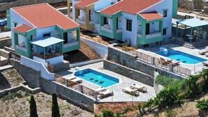A modern resort with multiple villas, each featuring a private pool and outdoor seating area. - Villa Ariadni Agia pelagia close to the beach up to7-8 quests (Agia Pelagia)