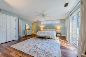 A bedroom with a bed, a dresser, a mirror, a nightstand, and a window. - Updated Home, Very Close to the Beach! (Duck)