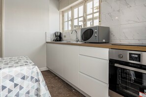 Microwave, oven, coffee/tea maker, dining tables