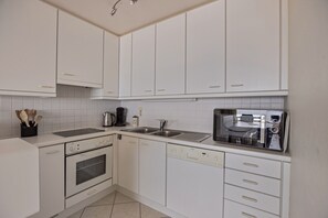 Oven, stovetop, coffee/tea maker, dining tables