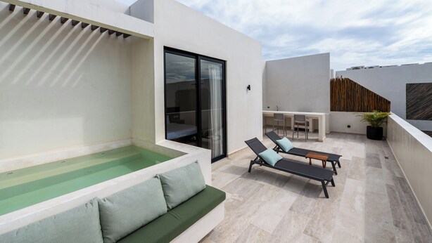 A modern outdoor living area with a pool, lounge chairs, and a dining area. - Luxury Penthouse│Private Rooftop Pool│Concierge (Tulum)