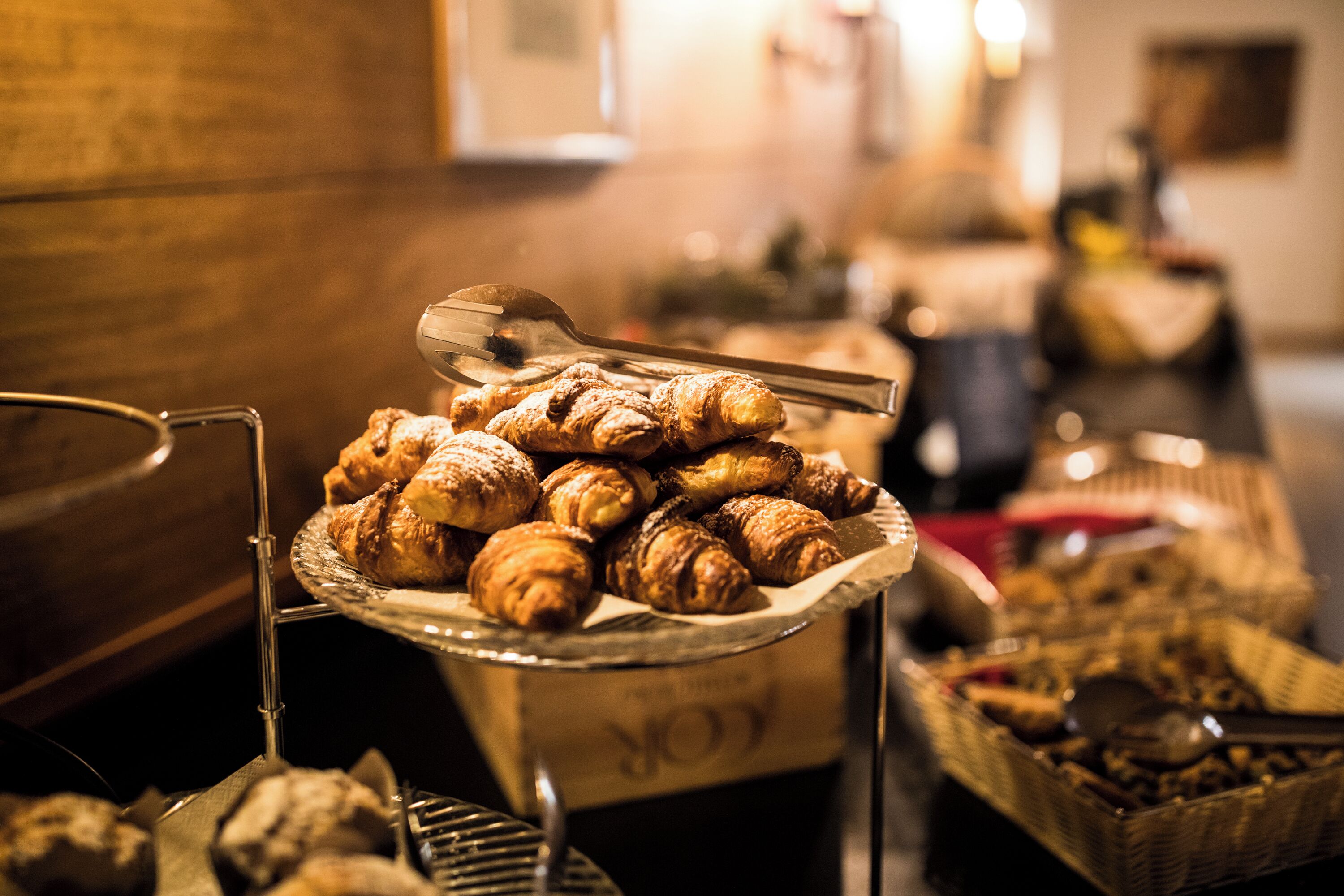 A buffet table with various pastries and a box labeled "FORK".