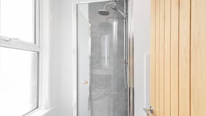 A glass-enclosed shower with a handheld showerhead and a wall-mounted faucet. - Host Stay Goathland at the Sandbeck (Whitby)