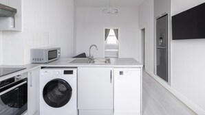 A modern kitchen with a built-in washer, oven, microwave, and refrigerator. - Host Stay Aberdeen Walk Apartment (Scarborough)