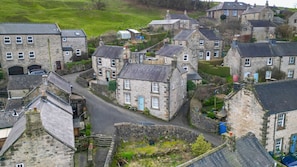 A cluster of stone buildings with a narrow street, likely a historic village. - Host Stay Bradley House (Matlock)