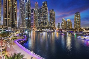 A waterfront cityscape with high-rise buildings and a marina.