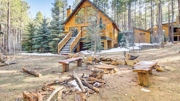A log cabin with a staircase leading to the entrance, surrounded by a forest. - Family-friendly Cabin w/ Fire Pit in Forest Lakes (Forest Lakes)