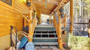 A wooden cabin with a porch, a welcome mat, and a sign that reads "Welcome to Cabin." - Family-friendly Cabin w/ Fire Pit in Forest Lakes (Forest Lakes)