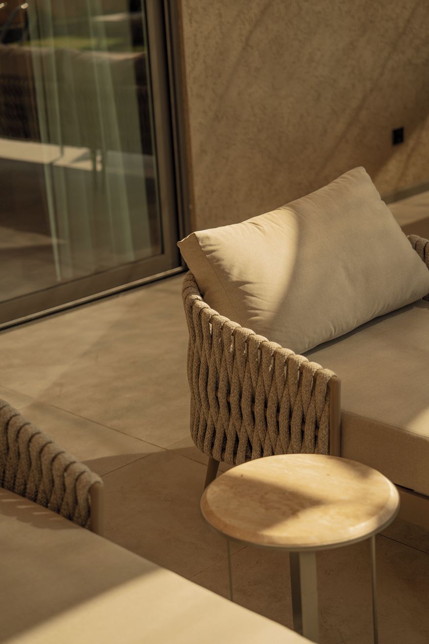Et moderne loungeområde med en sofa og en lænestol, begge med et struktureret design.