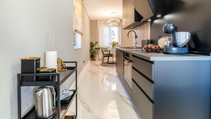A modern kitchen with a marble countertop, a built-in oven, and a coffee machine. - Hedera Estate, Hedera A57 (Dubrovnik)