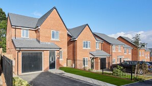 A row of modern brick houses with attached garages, a well-maintained lawn, and a clear blue sky. - Host Stay Aronora Guest House (Blaydon on Tyne)
