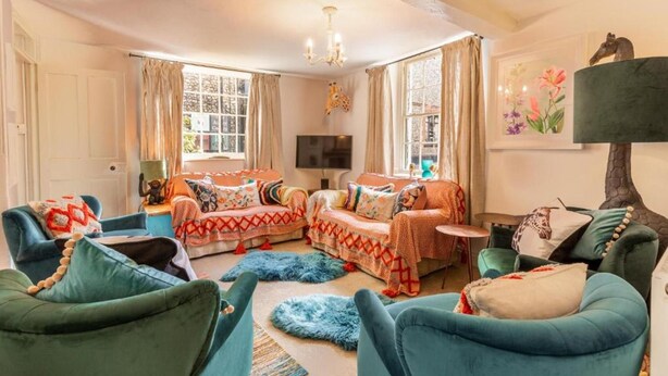 A cozy living room with a fireplace, comfortable seating, and a television.