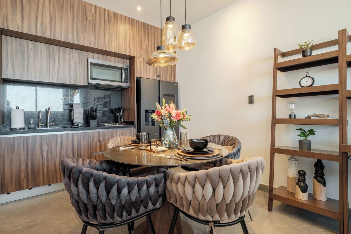 Open dining and kitchen with stylish shelving and fresh blooms, a social heart for the home