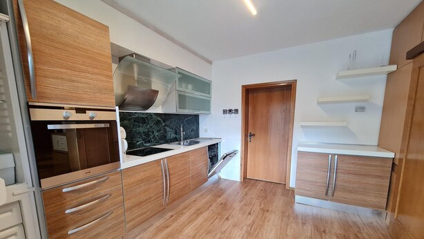 A modern kitchen with wooden cabinets, a built-in oven, and a microwave. - Wonderful Apartment Close to the ski Slope (Bad Kleinkirchheim)