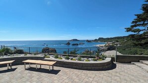 A patio area with a bench and a view of the ocean. - Amazing Ocean Views - Two Apartments! [Units 1 & 2] (Brookings)