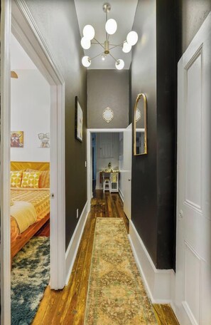 The contrast of rugged original wood floors and modern lighting and design creates a time-traveling vibe, blending the past with the present. - Delightful Design & Cowboy Pool by French Quarter (New Orleans)