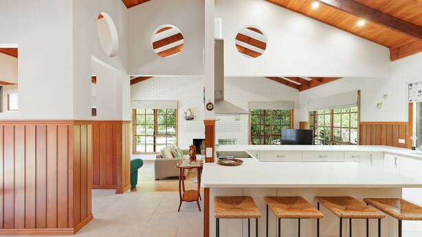 A spacious kitchen with a large island, wooden beams, and large windows. - Time and Tide in Inverloch (Inverloch)