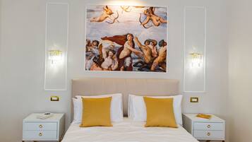 A hotel room with a large bed, two bedside tables, and a wall-mounted painting of cherubs.