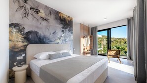 Ein modernes Schlafzimmer mit einem großen Bett, einem Nachttisch, einem Kleiderschrank und Blick auf eine üppige Landschaft durch eine Glastür.