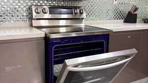 A kitchen with a built-in microwave, oven, and toaster. - Country Space Villa (Gated Community, private pool, close to turtle watching) (Sangre Grande)