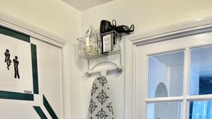 A bathroom with a toilet, a shower curtain, and a towel rack with a towel hanging. - The Express Apartment (Ilford)