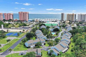 A coastal residential area with multiple-story buildings, a marina, and a sports complex.