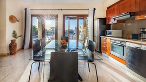 A modern kitchen with wooden cabinets, a microwave, and a dishwasher. - Hg07 Adjacent to Aphrodite Hills- Private Pool, Large Terrace (Kouklia)