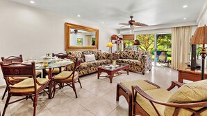 A spacious living room with a dining area, a large sofa, and a ceiling fan. - Remodeled, A/C,-KS C2C - Sullivan Properties (Lahaina)