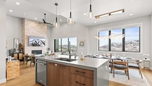 Una cocina moderna con una isla central, armarios de madera y lavavajillas integrado.