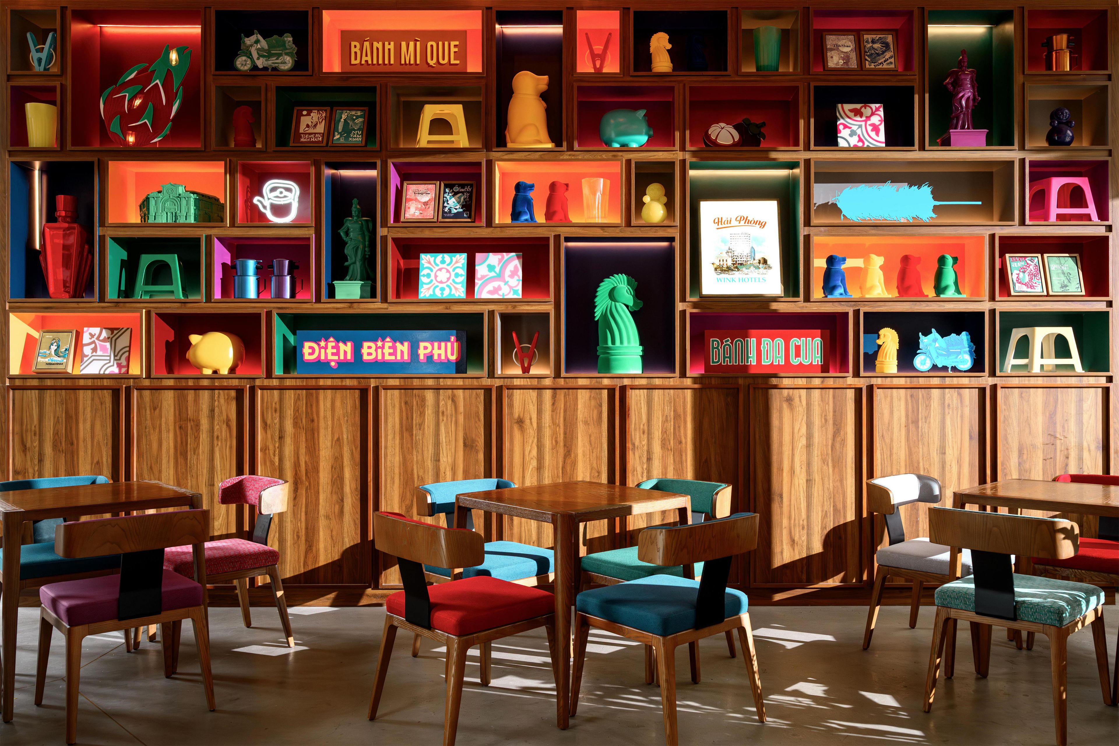A restaurant with wooden paneling and multiple tables and chairs.