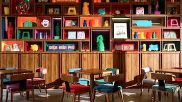 A restaurant with wooden paneling and multiple tables and chairs.