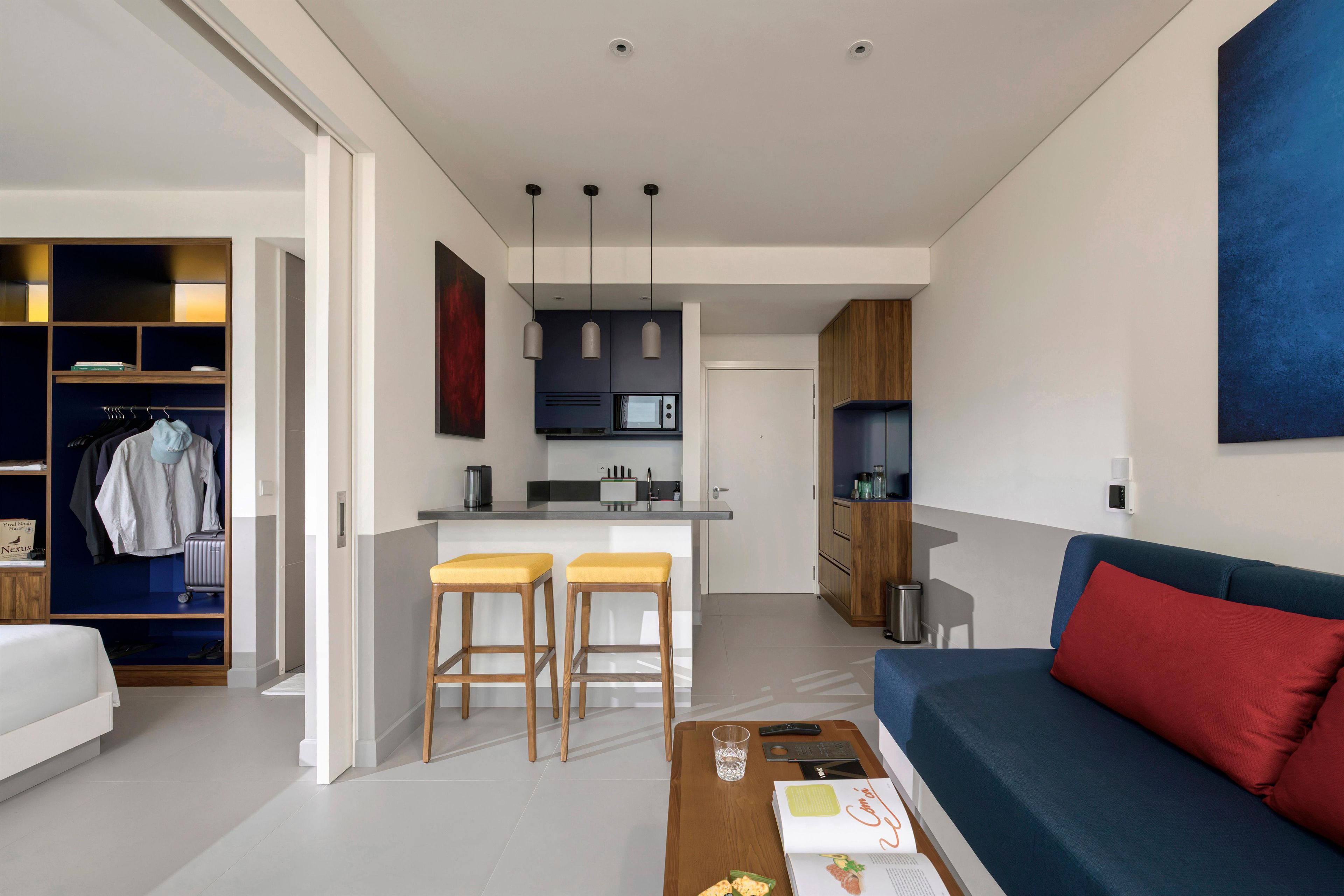 A modern apartment with a kitchen, dining area, and living room.