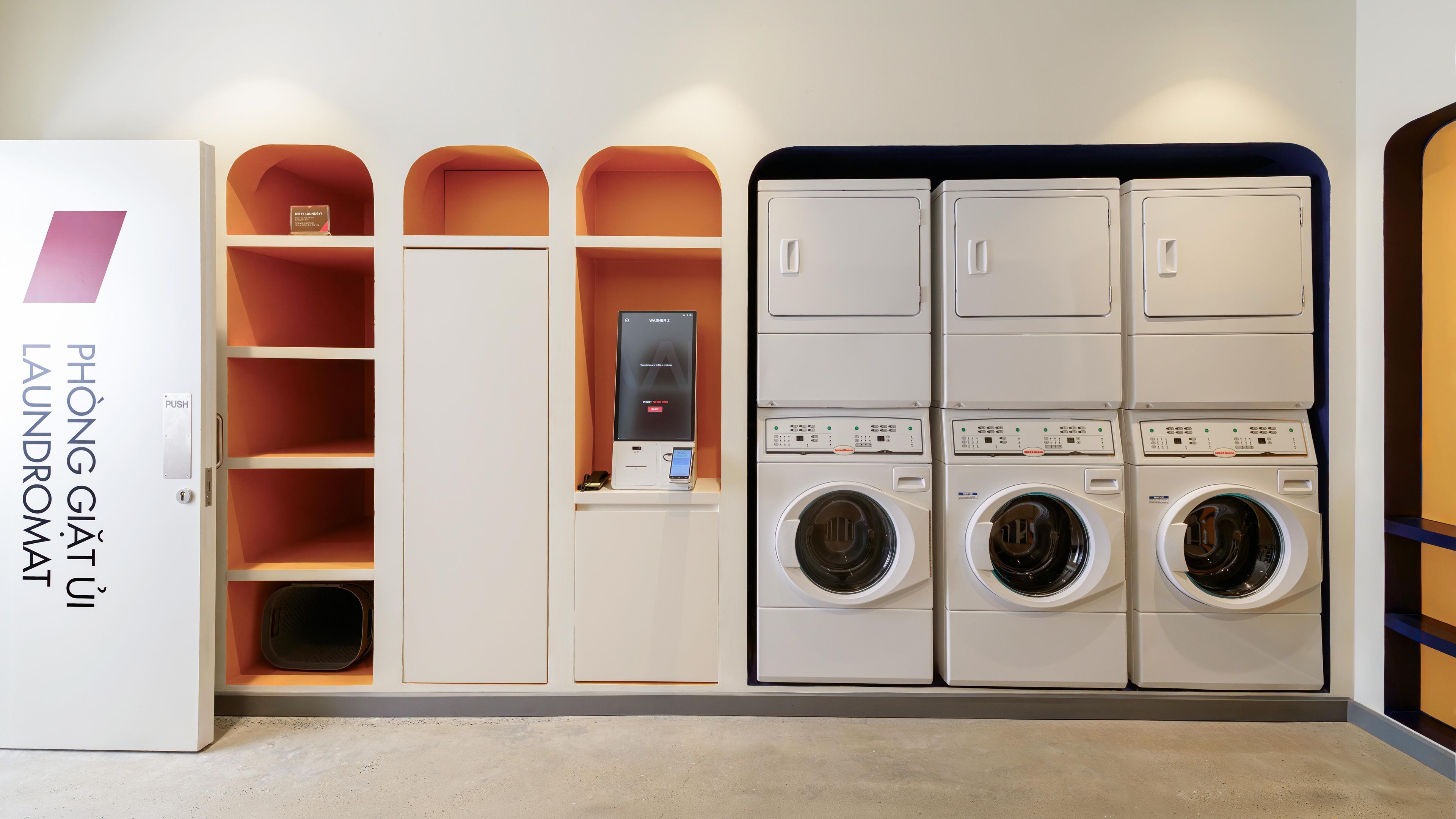 A laundry facility with a push button, a washing machine, and a dryer.