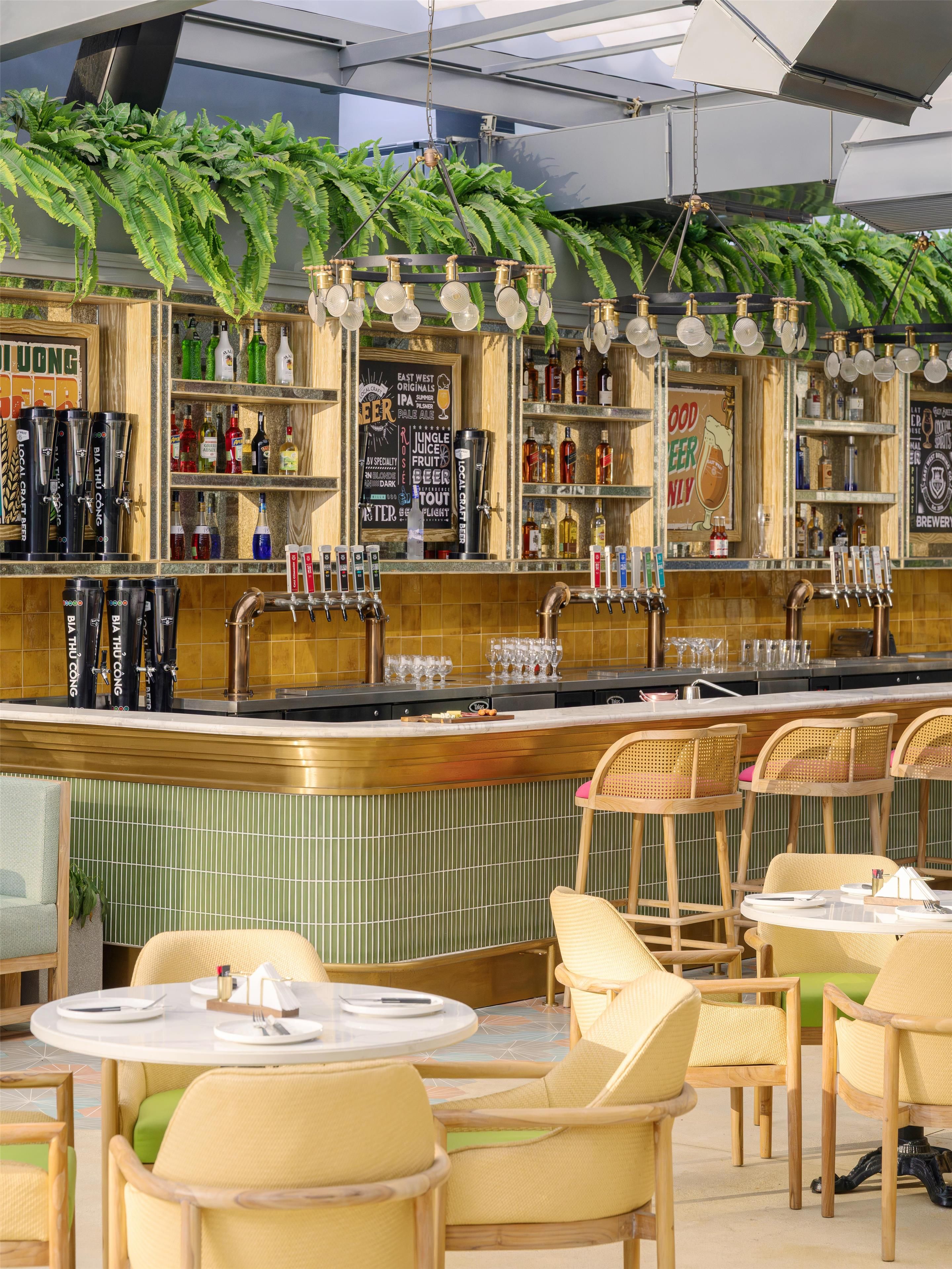 A bar area with multiple taps, shelves of bottles, and a menu board.