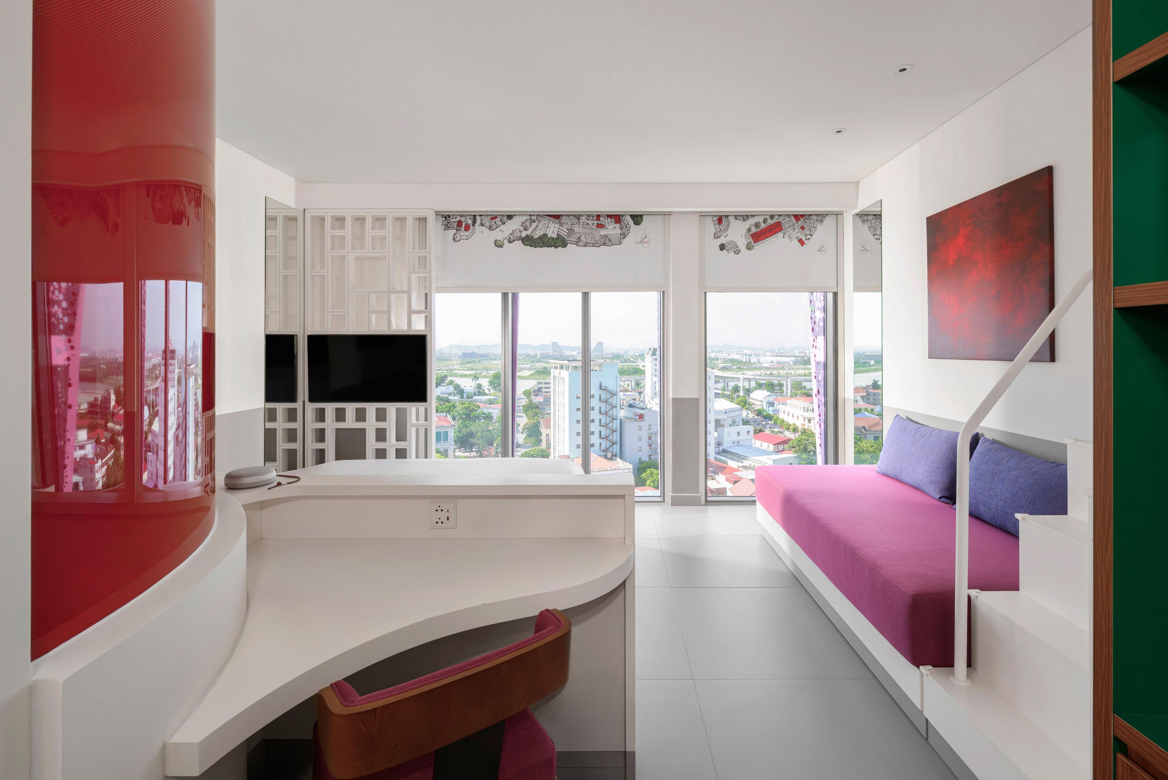 A modern living room with a large window, a flat-screen TV, a sofa, and a red accent wall.