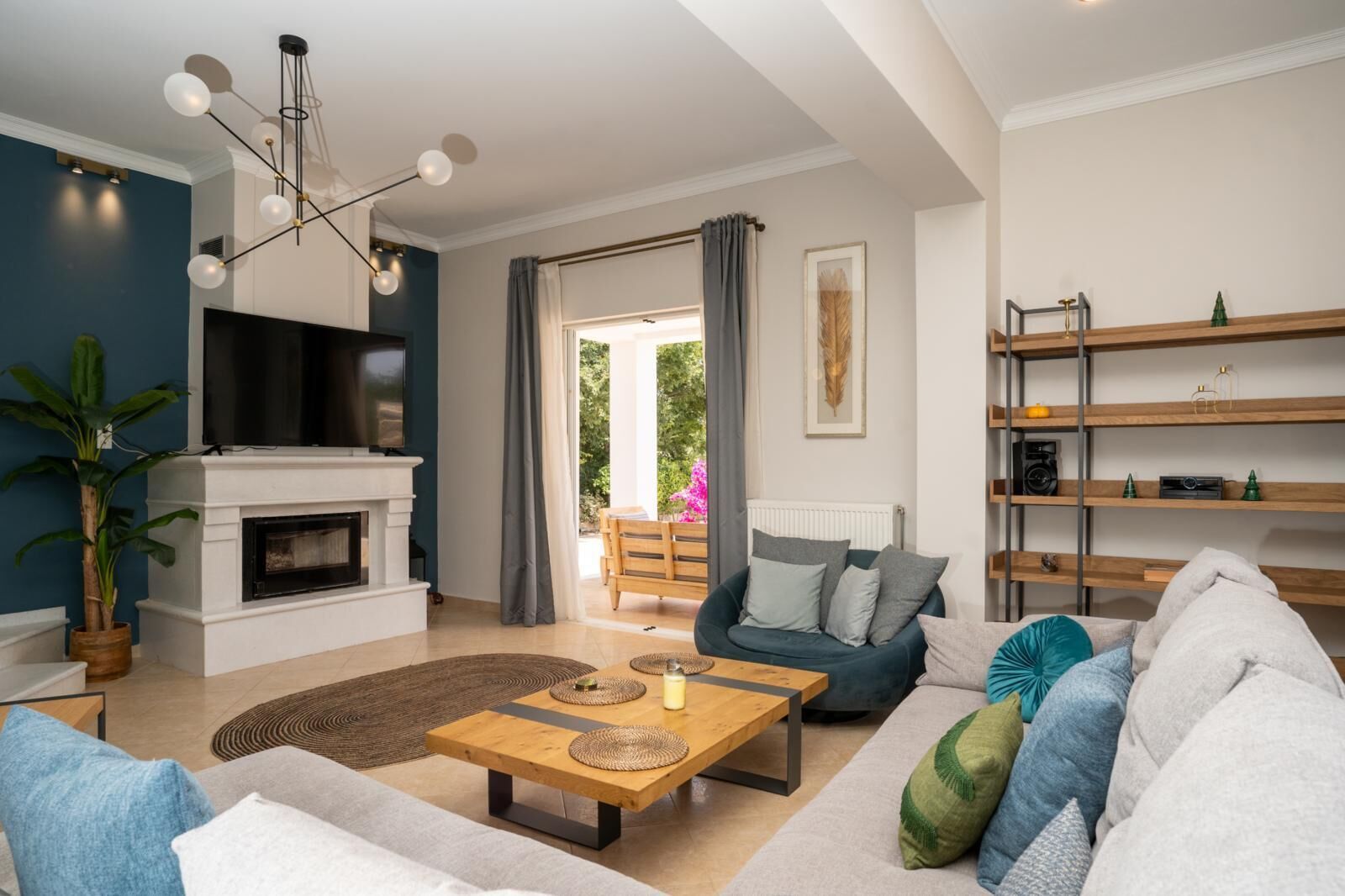A modern living room with a fireplace, a sofa, a coffee table, and a bookshelf.