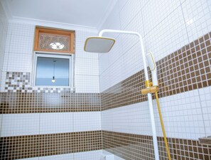 Combined shower/tub, bathrobes, slippers, towels