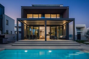 A modern two-story house with a covered patio and a swimming pool. - Villa Acacia with heated pool (Petrcane)