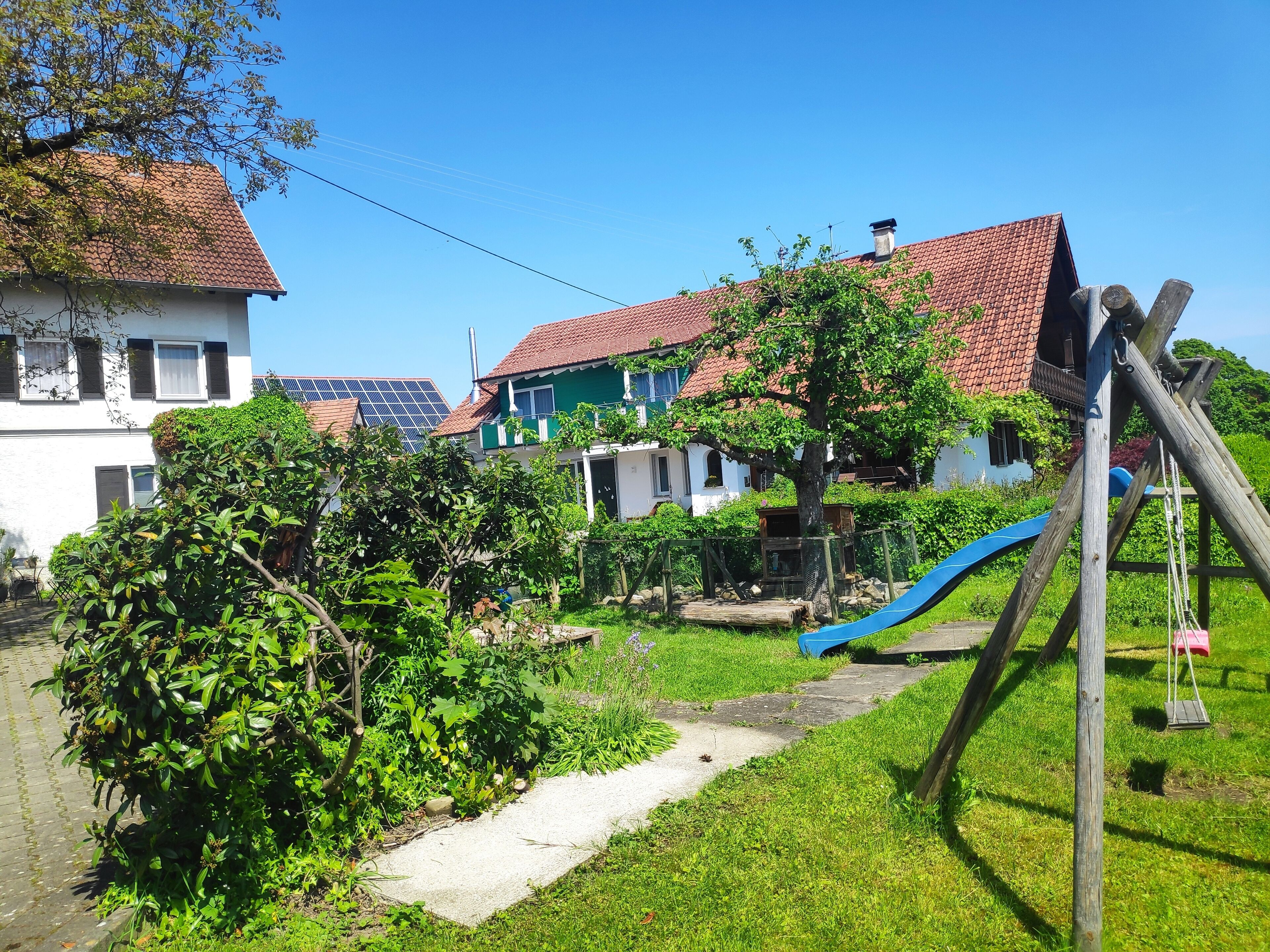 A residential area with houses, a playground, and a path.