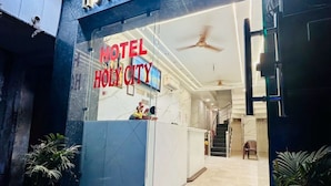 The exterior of Hotel Holy City with a reception desk and a staircase leading to the entrance. - Hotel Holy City (Amritsar)