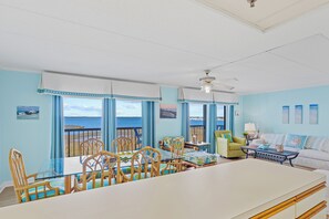 Enjoy ocean views from this room, which features a dining table, sofa, and coffee table.