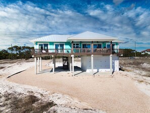 A two-story beachfront house with a balcony and a covered garage. - Dragonfly Shores - Beach View, Pet Friendly, Beach Gear Credit Included! (St George Island)